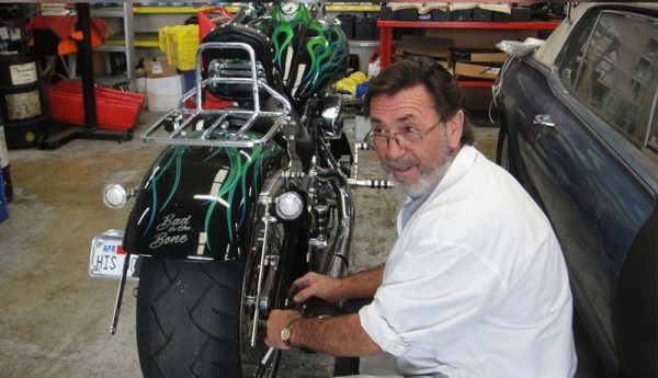 Bob Bowen working on his motorcycle