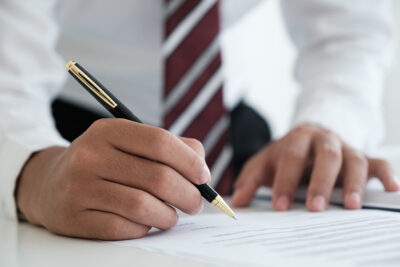 Real Estate Investment Tips - Businessman signing Rental Property Agreement